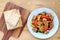 Stack of fresh Tempeh and colorful vegetables salad with roasted Tempeh cubes