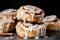 stack of freshly baked cinnamon buns, drizzled with icing and sprinkled with cinnamon