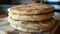 Stack of freshly baked flatbread on a wooden surface