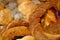 A stack of freshly baked Turkish bagel simit in a copper tray, breakfast snacks in Turkey. Top view of fresh baked goods.