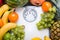 Stack of fruits over white weight scale.