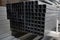 Stack of galvanized rectangular steel pipes for building materials. Production and construction of drywall walls. the