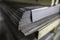 a stack of galvanized thick hot rolled steel sheets in a warehouse