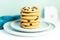 A stack of Giant cookies with raisins lies on a light green plate.