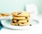 A stack of Giant cookies with raisins lies on a light green plate.