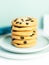 A stack of Giant cookies with raisins lies on a light green plate.