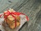 A stack of gift cookies wrapped with a red festive ribbon on a wooden background. Copy space
