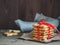 A stack of gift cookies wrapped with a red festive ribbon on a wooden background. Copy space