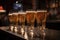 stack of glasses filled with draught beer, ready to be served at the bar