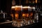 stack of glasses filled with draught beer, ready to be served at the bar