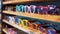A stack of glasses on a wooden shelf with each pair showcasing a different shape and color. Some have round frames in