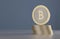 Stack of gold and silver bitcoins as example for crypto-currency in front of blurred blue background