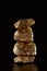 Stack of gold textured shiny stones isolated on black.