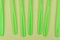 stack of green plastic forks on a green background
