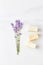 Stack of handmade soap, mini lavender bouquet on marble background. flat lay, top view