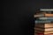 Stack of hardcover books on black background