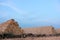 Stack of hay bales in the field after harvest. Yellow rolls of straw at the end of summer or at the beginning of the autumn season