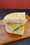 Stack of Herbed Italian Focaccia Bread Slices on Wooden Breadboard