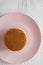 Stack of homemade Dutch stroopwafels with honey-caramel filling on a pink plate, view from above. Flat lay, overhead