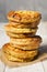 Stack of homemade meat pies on a rustic table