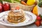 stack of homemade pancake with maple syrup and strawberry topping