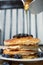 Stack of homemade pancakes prepared with blueberries and honey on an antique plate