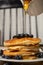 Stack of homemade pancakes prepared with blueberries and honey on an antique plate