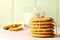 A stack of homemade peanut butter cookies tied with twine. Broken biscuit and glass of milk.