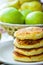 Stack of Homemade Scrumptious Cottage Cheese Pancakes Patties on White Plate. Apples Pear in Wicker Basket. Rustic Provence Style