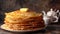 Stack homemade thin pancakes with piece of butter on white plate on brown background, rustic style, festive dish for