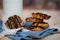 A stack of homemade vegan oat cookie with banana, date and almond topped with chocolate placed on blue napkin