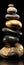 Stack of Impossibly High Polished Black and Gold Zen Rocks on Black Background. Generative ai