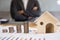 Stack of increasing coins and house model with businessman cross