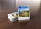 Stack of instant photos on wooden surface 3D rendering