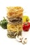 Stack of italian pasta, tagliatelle, mushroom slices and bell peppers