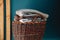 Stack of knitted sweaters on wicker basket