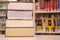 Stack of large books and a library shelf