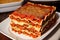 A stack of lasagna with a slice of lasagna on top on a wooden table. Generative AI