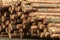 Stack of logs on sawmill, close up.