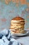 A stack of lush punkcakes for breakfast on a gray background. High pile of delicious pancakes with berries.