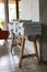 Stack of magazine books on wooden table shelf in living room