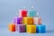 Stack of magenta square wax candles on electric blue background