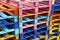 Stack of many multicolor painted wooden pallets