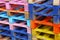 Stack of many multicolor painted wooden pallets