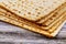 Stack of matzah or matza on a vintage wood background