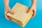 Stack of matzo in female hands on blue background