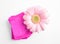 Stack of menstrual pads and gerbera flower on white. Gynecological care