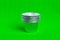 Stack metal baking cups for muffins and cupcakes on a green background minimal creative concept. Space for copy.