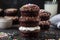 stack of mini chocolate cupcakes with fluffy frosting and sprinkles