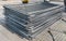 A stack of modular steel fence elements made of galvanized steel